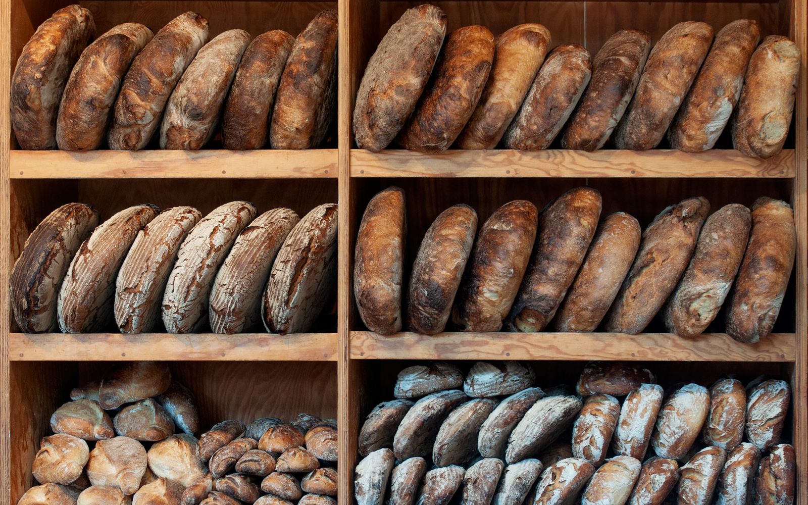 Fresh sourdough loaves and pastries on a wooden counter